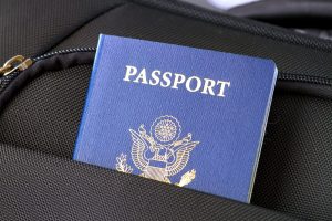 A U.S. passport sticking out of a backpack.